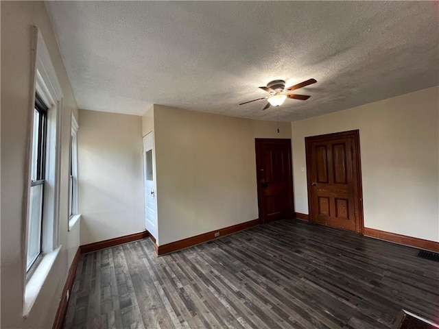 167 S 15th St, South Side, PA 15203 - spare room featuring baseboards, a textured ceiling, dark wood-style flooring, ceiling fan, and plenty of natural light