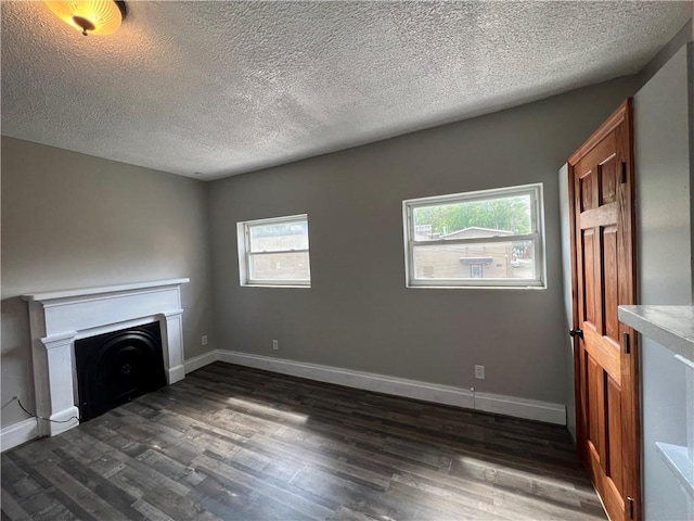 167 S 15th St, South Side, PA 15203 - unfurnished living room with dark wood finished floors, a textured ceiling, a fireplace, and baseboards