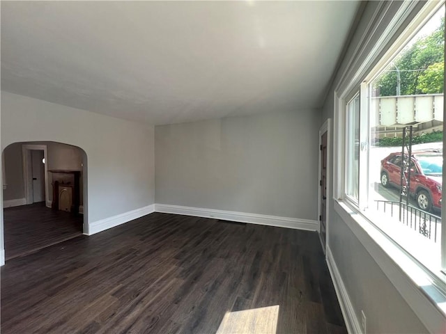 167 S 15th St, South Side, PA 15203 - spare room with arched walkways, baseboards, and dark wood finished floors