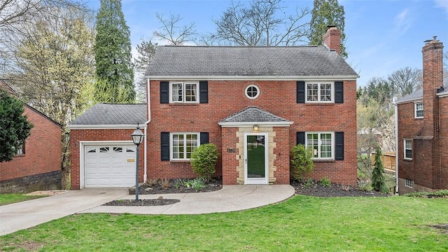 4720 Rolling Hills Rd, Whitehall, PA 15236 - view of front of home with driveway, an attached garage, a chimney, a front lawn, and brick siding