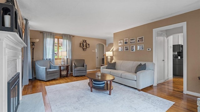 4720 Rolling Hills Rd, Whitehall, PA 15236 - living room with arched walkways, wood finished floors, and baseboards
