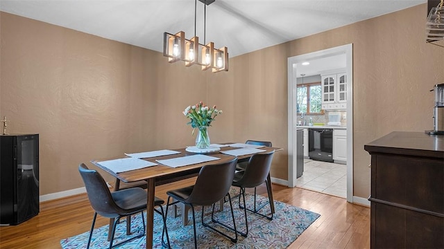 4720 Rolling Hills Rd, Whitehall, PA 15236 - dining space featuring a textured wall, light wood-type flooring, a chandelier, and baseboards