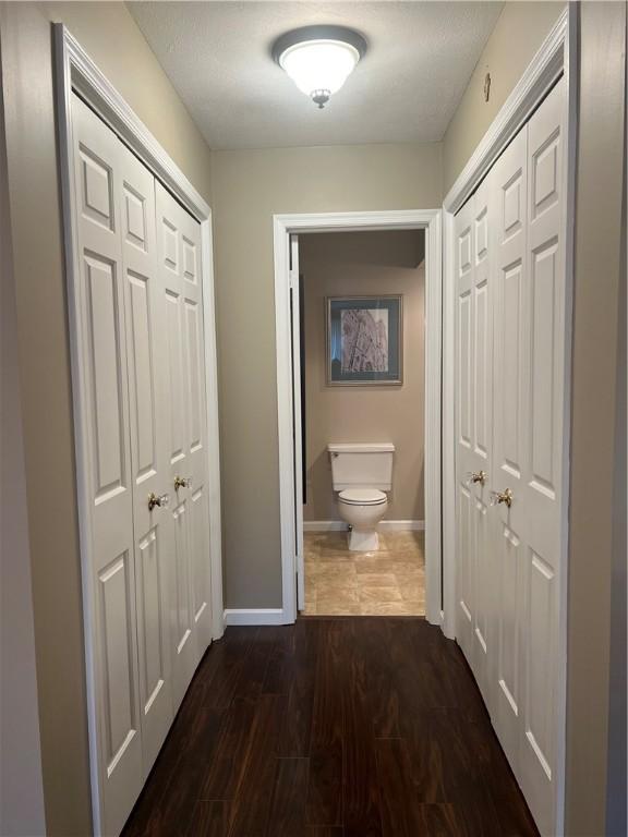 286 Windsor Rdg Unit 26, Neshannock Twp, PA 16105 - hallway featuring baseboards and dark wood-style floors