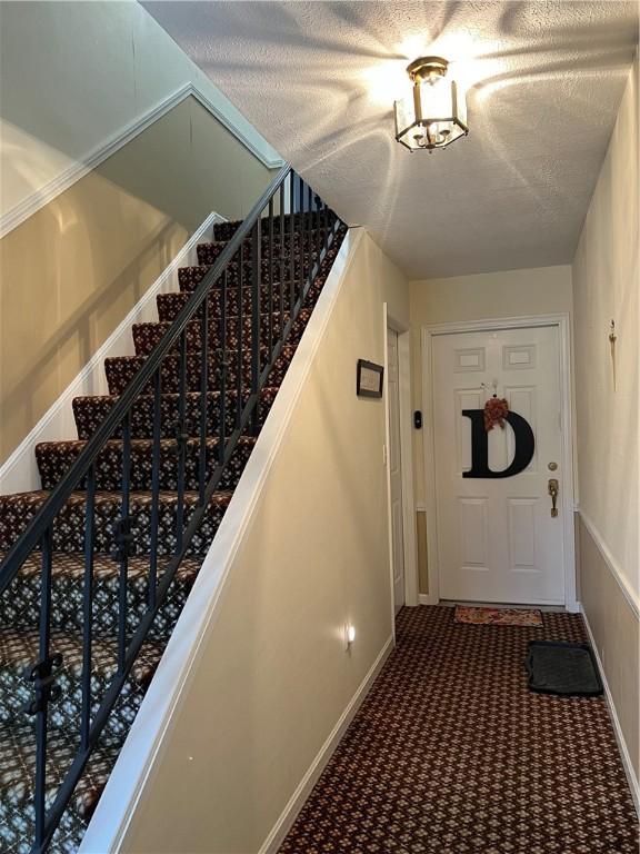 286 Windsor Rdg Unit 26, Neshannock Twp, PA 16105 - entryway with baseboards, carpet, and stairway