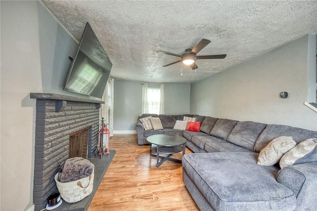 216 Siebert, Ross Twp, PA 15237 - living area featuring light wood-type flooring, a ceiling fan, a textured ceiling, and a brick fireplace