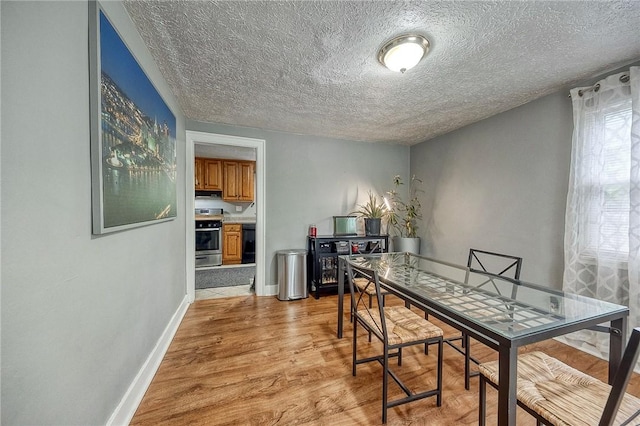 216 Siebert, Ross Twp, PA 15237 - dining area featuring light wood-type flooring, a textured ceiling, and baseboards