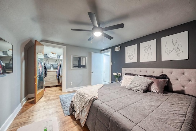 216 Siebert, Ross Twp, PA 15237 - bedroom featuring a walk in closet, light wood finished floors, baseboards, a closet, and ceiling fan