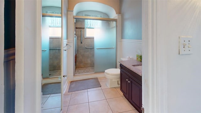2120 Delaware Ave, Swissvale, PA 15218 - full bathroom featuring tile patterned flooring, wainscoting, a stall shower, toilet, and vanity