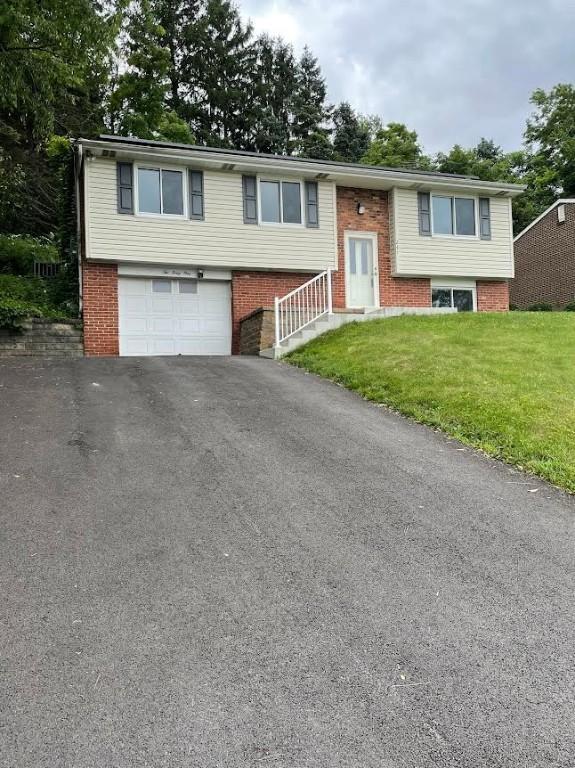 241 Willow Dr, Monroeville, PA 15146 - raised ranch with brick siding, a front yard, asphalt driveway, and an attached garage