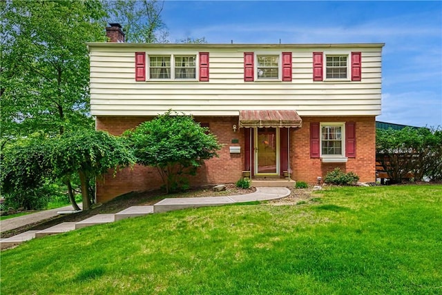 3329 Forest Rd, Bethel Park, PA 15102 - colonial house featuring a chimney, a front yard, and brick siding
