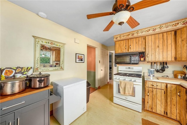 3329 Forest Rd, Bethel Park, PA 15102 - kitchen featuring black microwave, white range with gas cooktop, light countertops, light wood finished floors, and a ceiling fan
