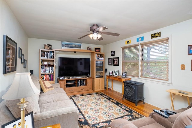 3329 Forest Rd, Bethel Park, PA 15102 - living room with a wood stove, a ceiling fan, and wood finished floors