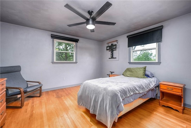 3329 Forest Rd, Bethel Park, PA 15102 - bedroom featuring multiple windows, light wood finished floors, and baseboards