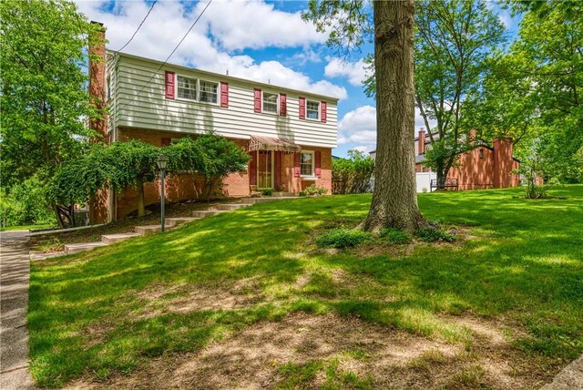 3329 Forest Rd, Bethel Park, PA 15102 - rear view of house with brick siding, a chimney, and a yard
