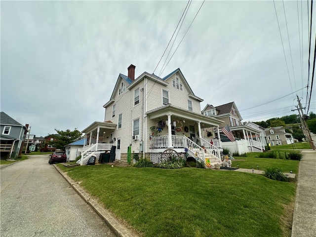453 N W St, Waynsbrg/Frankln Twp, PA 15370 - view of front of house with covered porch, a front lawn, and a chimney