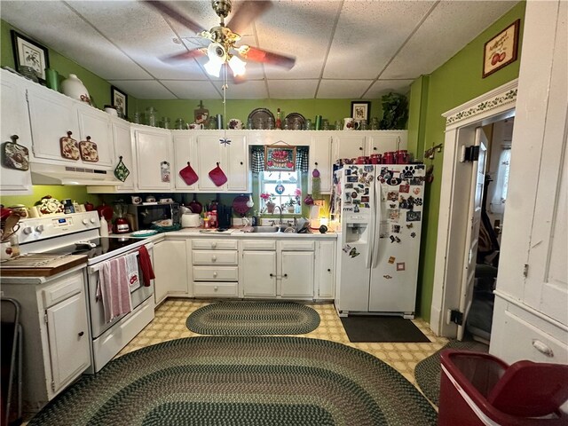 453 N W St, Waynsbrg/Frankln Twp, PA 15370 - kitchen with white appliances, under cabinet range hood, white cabinets, light floors, and ceiling fan
