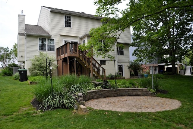 319 Hummingbird Cir, Cranberry Twp, PA 16066 - back of property featuring stairway, a lawn, a chimney, and a deck