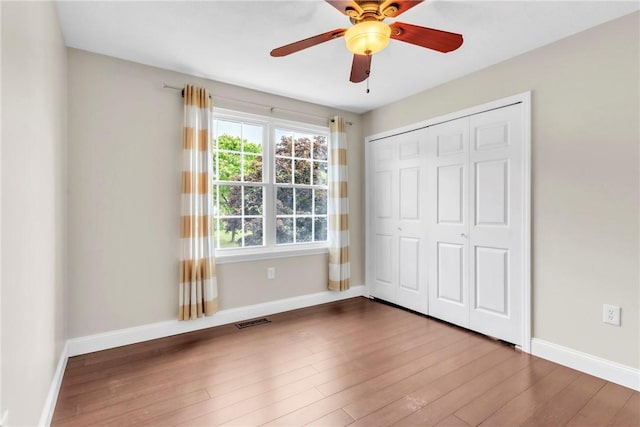 319 Hummingbird Cir, Cranberry Twp, PA 16066 - unfurnished bedroom with wood finished floors, baseboards, a closet, and a ceiling fan