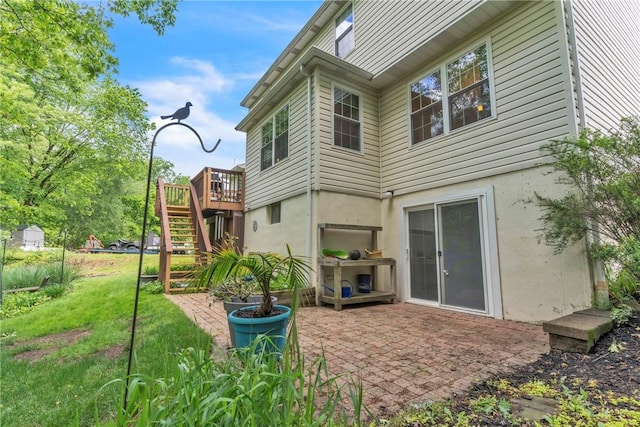 319 Hummingbird Cir, Cranberry Twp, PA 16066 - rear view of house featuring stairway, a patio, a lawn, a deck, and stucco siding