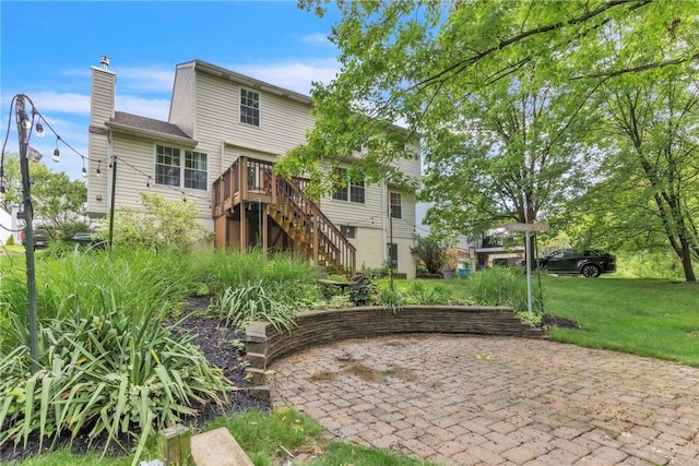 319 Hummingbird Cir, Cranberry Twp, PA 16066 - back of house with stairway, a chimney, a deck, and a yard