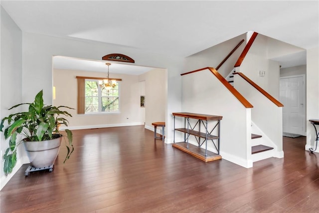 319 Hummingbird Cir, Cranberry Twp, PA 16066 - unfurnished room with a chandelier, stairs, wood finished floors, and baseboards