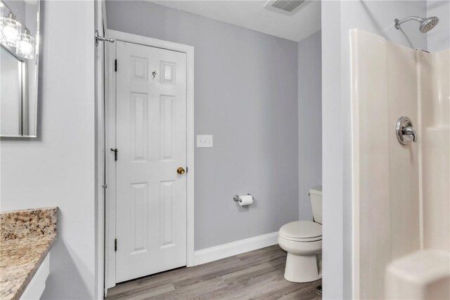 319 Hummingbird Cir, Cranberry Twp, PA 16066 - bathroom featuring wood finished floors, a shower, vanity, toilet, and baseboards