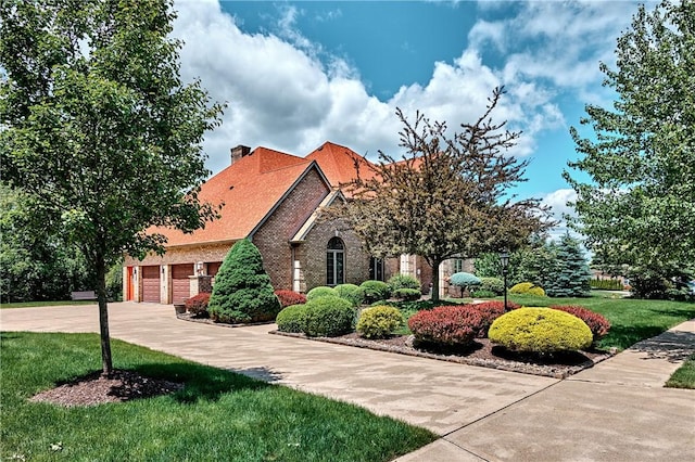 133 Ridgemont Dr, Cranberry Twp, PA 16066 - view of front of property with brick siding, a chimney, concrete driveway, and a front lawn