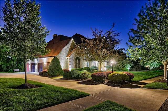 133 Ridgemont Dr, Cranberry Twp, PA 16066 - view of front of home with a front yard, an attached garage, concrete driveway, brick siding, and a chimney