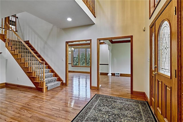 133 Ridgemont Dr, Cranberry Twp, PA 16066 - foyer featuring a towering ceiling, wood finished floors, baseboards, stairway, and ornate columns