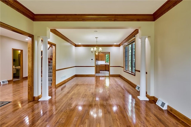133 Ridgemont Dr, Cranberry Twp, PA 16066 - unfurnished dining area with decorative columns, light wood-style floors, stairway, baseboards, and crown molding