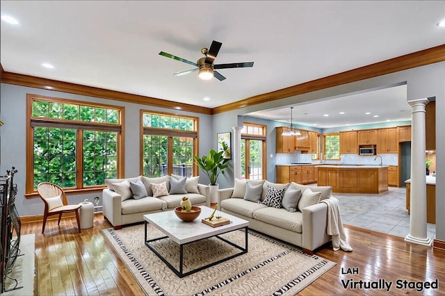 133 Ridgemont Dr, Cranberry Twp, PA 16066 - living room with ceiling fan, light wood finished floors, ornate columns, crown molding, and baseboards