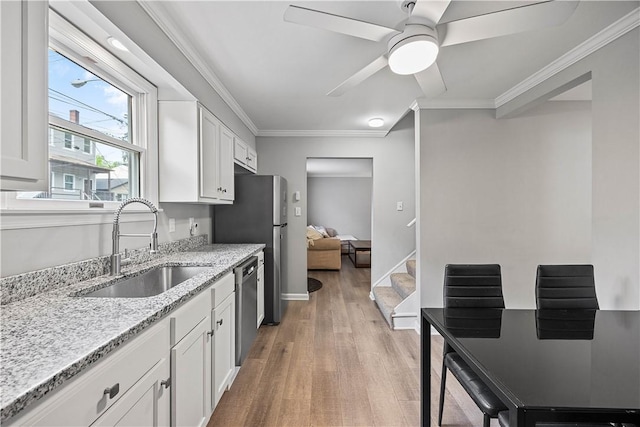 48 Glenmore Ave, West View, PA 15229 - kitchen featuring a sink, stainless steel dishwasher, white cabinets, light wood-style flooring, and ornamental molding