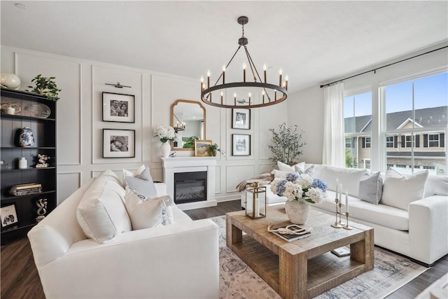 436 Greenwood Dr, North Strabane, PA 15317 - living room featuring a decorative wall, a chandelier, wood finished floors, and a glass covered fireplace