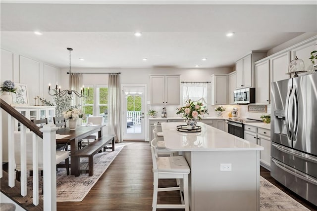 436 Greenwood Dr, North Strabane, PA 15317 - kitchen featuring stainless steel appliances, a center island, a kitchen breakfast bar, light countertops, and a chandelier