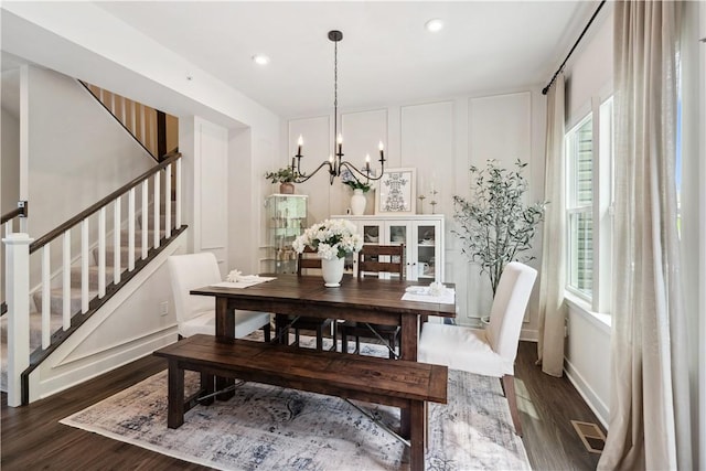 436 Greenwood Dr, North Strabane, PA 15317 - dining room with stairs, dark wood-style floors, a chandelier, plenty of natural light, and a decorative wall