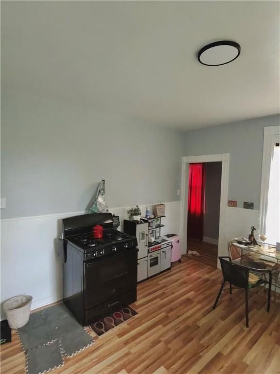 332 Hammond St, Sheraden, PA 15204 - kitchen featuring black gas stove and light wood-style floors