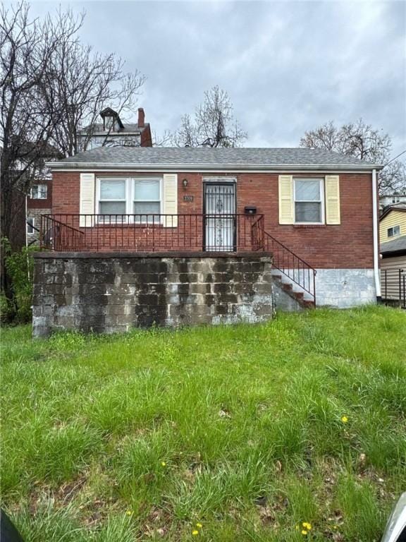 2709 Leland St, Perry Hilltop, PA 15214 - view of front of house with brick siding and a chimney