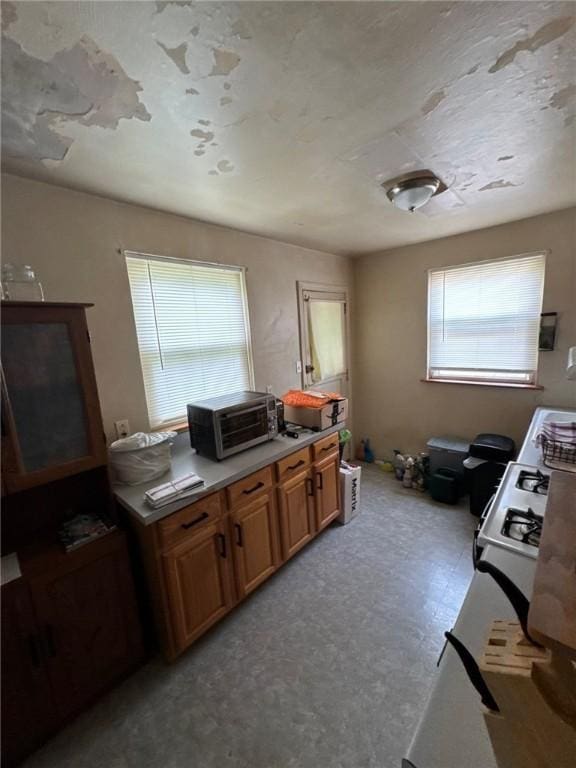 2709 Leland St, Perry Hilltop, PA 15214 - kitchen with brown cabinetry and light floors