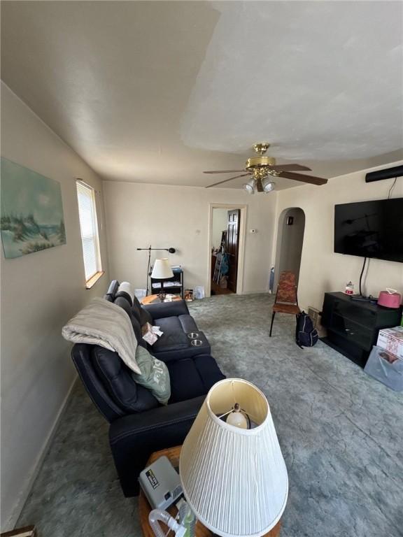 2709 Leland St, Perry Hilltop, PA 15214 - carpeted living room featuring arched walkways and a ceiling fan