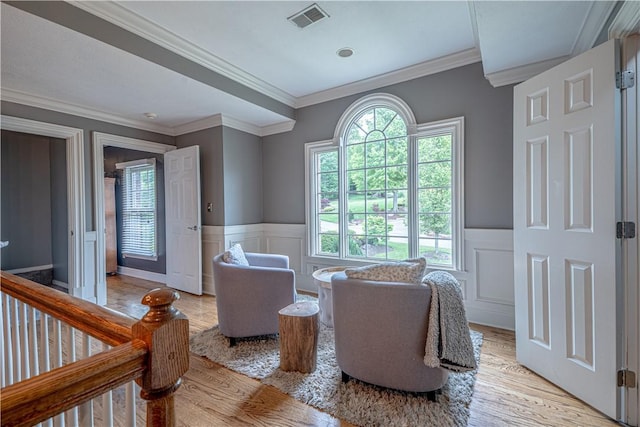 102 Maple Gln, Peters Twp, PA 15367 - living area with light wood finished floors, a decorative wall, wainscoting, and crown molding