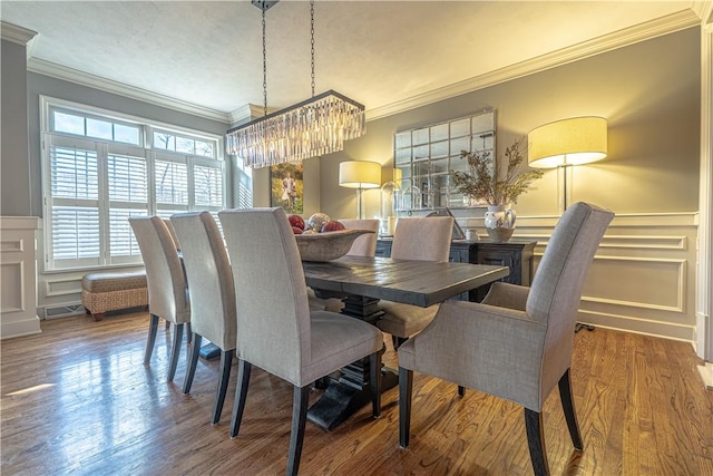 102 Maple Gln, Peters Twp, PA 15367 - dining area featuring ornamental molding, a decorative wall, a chandelier, a wainscoted wall, and wood finished floors