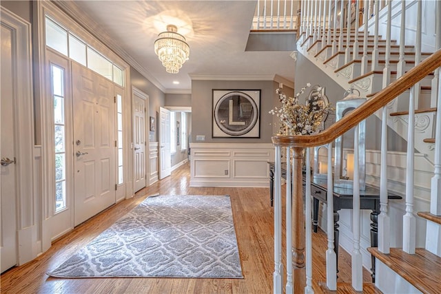 102 Maple Gln, Peters Twp, PA 15367 - entryway featuring crown molding, stairs, a chandelier, a decorative wall, and light wood-type flooring