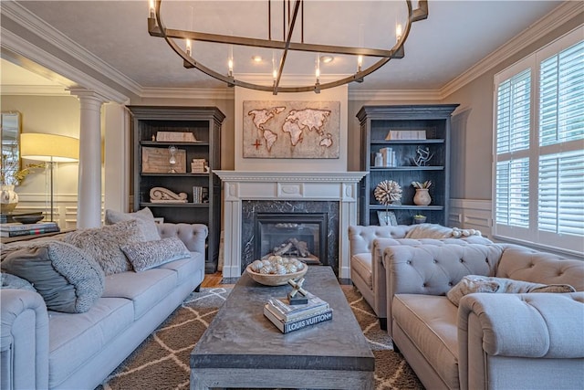 102 Maple Gln, Peters Twp, PA 15367 - living area with crown molding, a fireplace, a chandelier, and decorative columns