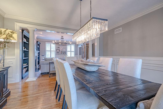 102 Maple Gln, Peters Twp, PA 15367 - dining space featuring a chandelier, crown molding, decorative columns, and light wood-type flooring