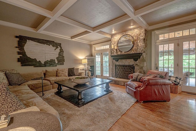 102 Maple Gln, Peters Twp, PA 15367 - living area featuring wood finished floors, healthy amount of natural light, coffered ceiling, a stone fireplace, and beam ceiling
