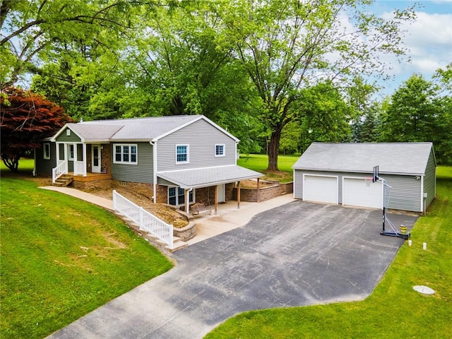 321 Green Acres Ln, Shenango Twp Law, PA 16101 - view of front of property with a porch, an outdoor structure, a detached garage, a front yard, and view of wooded area