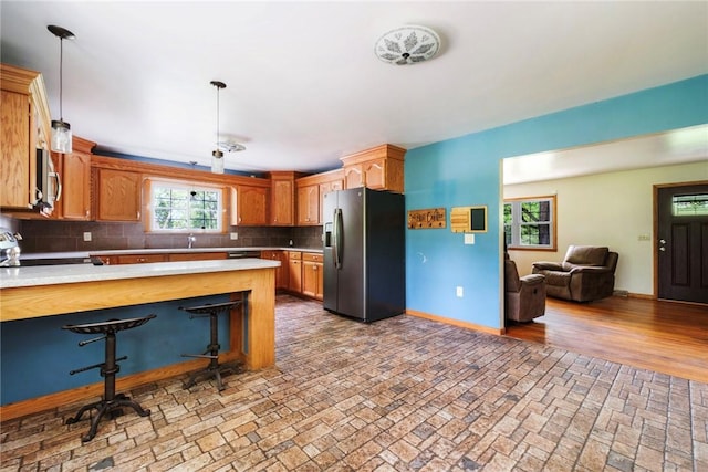 321 Green Acres Ln, Shenango Twp Law, PA 16101 - kitchen with appliances with stainless steel finishes, light countertops, decorative backsplash, open floor plan, and baseboards