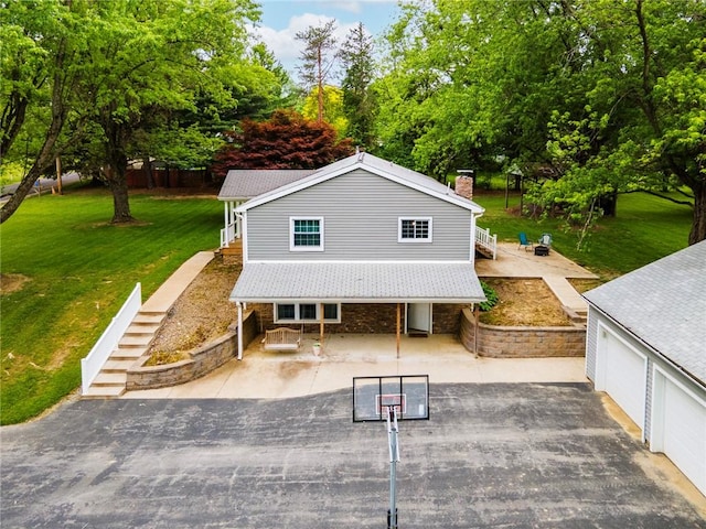 321 Green Acres Ln, Shenango Twp Law, PA 16101 - back of house with stairs, a yard, a chimney, and view of wooded area