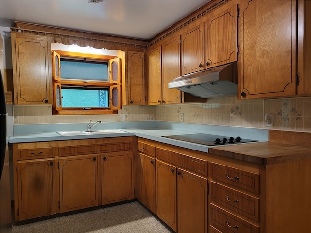 118 Wide View Ter, Unity Twp, PA 15650 - kitchen with under cabinet range hood, a sink, black electric cooktop, brown cabinetry, and decorative backsplash