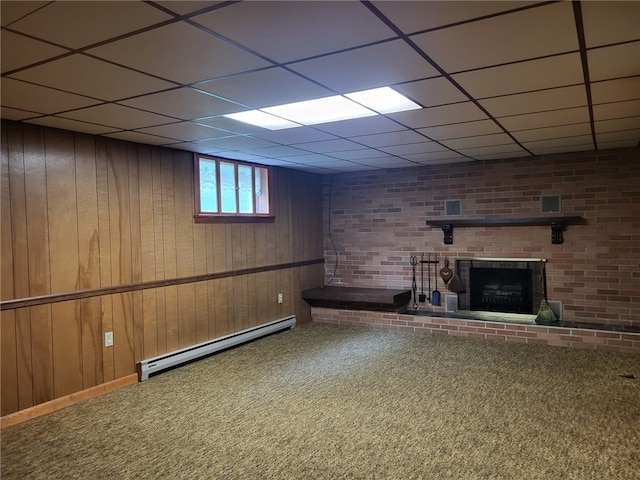 118 Wide View Ter, Unity Twp, PA 15650 - basement featuring a baseboard radiator, carpet flooring, a drop ceiling, a brick fireplace, and wood walls